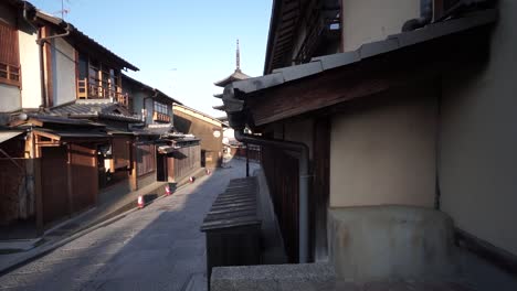 slide to hide a popular traditional japanese pagoda in an empty street with no tourists or people early in the morning in kyoto, japan