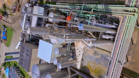 Aerial-vertical-shot-over-industrial-rum-factory-of-Ron-Barcelo-in-Dominican-Republic-with-storage-and-pipe-lines