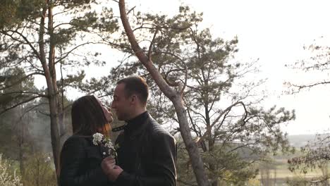 a couple sharing a romantic moment with flowers in a natural setting