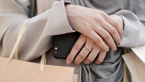 woman shopping with phone and bags