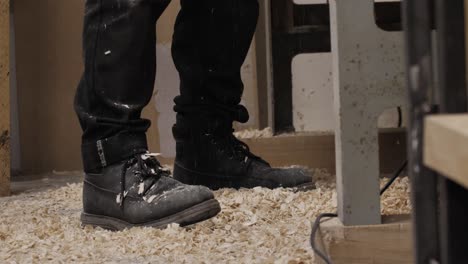 wood chips falling on a woodworker's feet