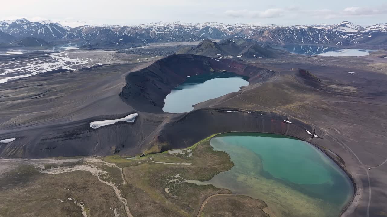 Aerial approaching shot of Ljotipollur lake in explosion crater of volcanic landscape. Iceland , Europe in summer. Wide shot. Clear water in crater hole