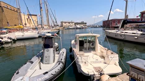 boats docked in a sunny naples harbor