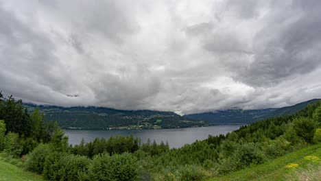 a peaceful timelapse of an austrian lake on a cloudy day, capturing the movement of clouds over the calm waters and surrounding landscape.