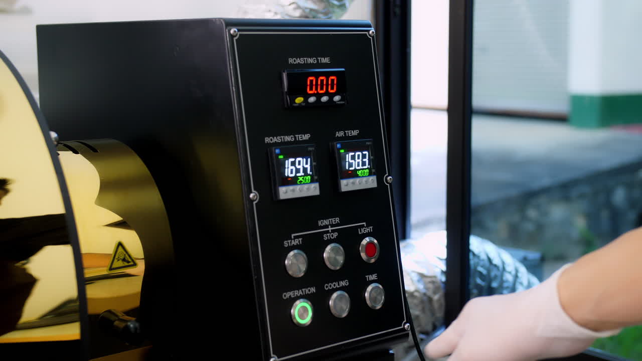 Hand Pushing Button On Control Panel To Start Work Of Coffee Roaster