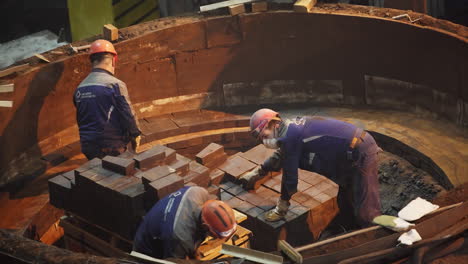 industrial workers building a furnace