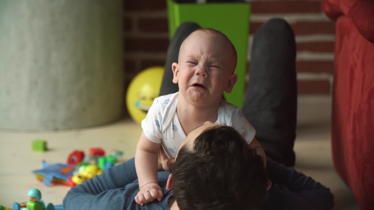 Father and baby bonding at home