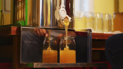 Pouring-Acacia-Honey-into-Jar-in-Apiary