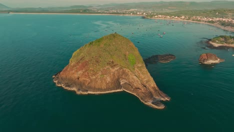 Drone-view-the-Hon-Yen-rock-island-on-Hon-Yen-sea,-a-famous-travel-destination-in-Phu-Yen-province,-central-Vietnam