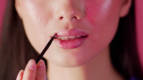 mujer aplicando lápiz labial
