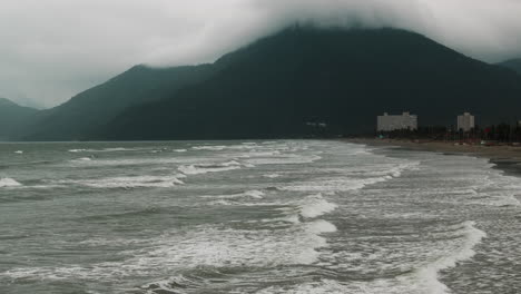 cloudy beach with mountains