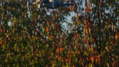 small white drone hovering in nature background