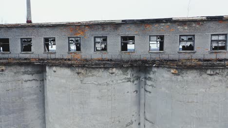 broken windows and walls of an old chemical plant. moss-covered concrete vault. ruins of industrial buildings. aerial view