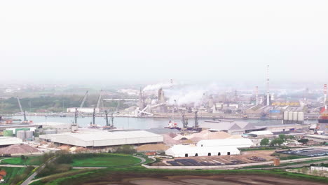 Aerial-view-of-the-industrial-and-port-area-of-Ravenna-,chemical-and-petrochemical-pole,thermoelectric,metallurgical-plants-and-hydrocarbon-refinery-and-liquefied-natural-gas-tanks-at-overcast-day