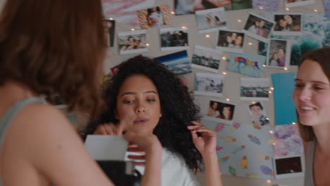 happy teenage girls taking photos together using instant photo camera best friends hanging out at home on weekend enjoying friendship