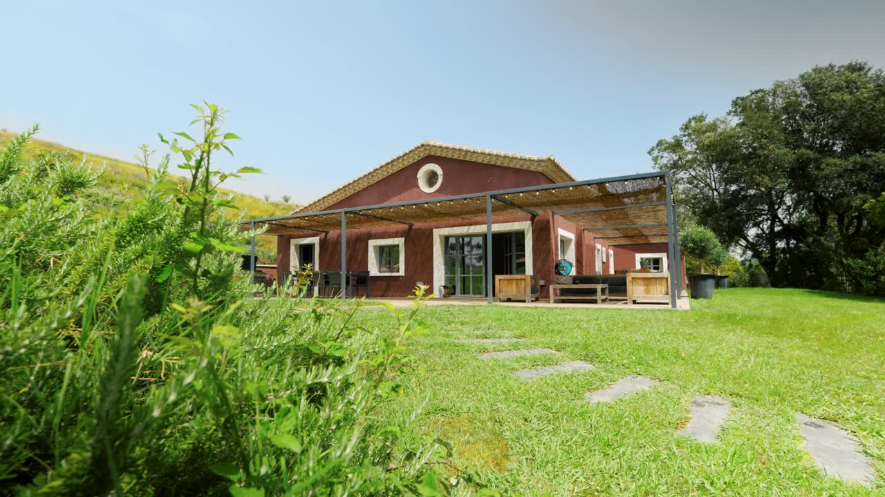 Slow establishing shot of a countryside cabin house in St Colombe