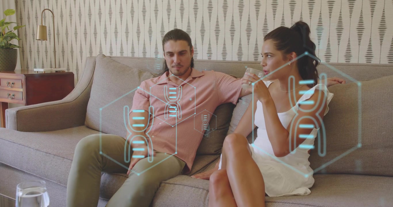 Couple sitting on gray sofa, discussing tech, woman sipping water holographic DNA strands appearing