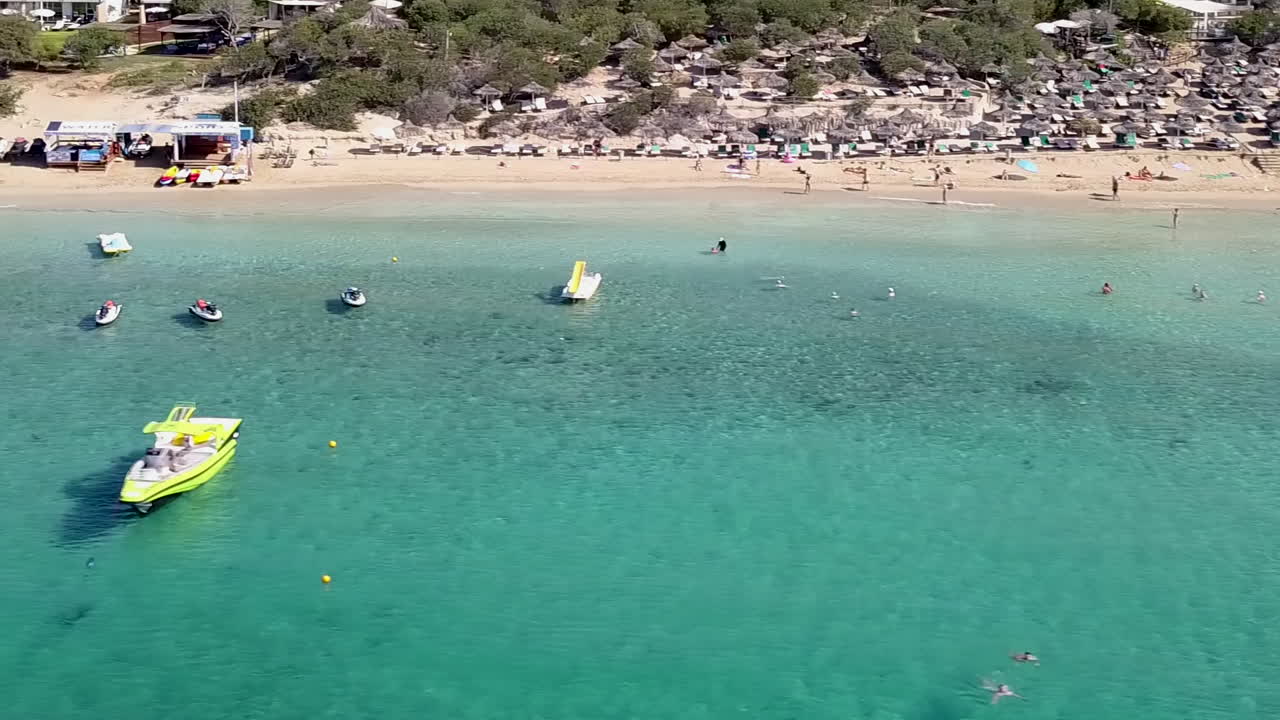 Aerial view of a holiday resort sandy beach, with beach umbrellas and sun beds
