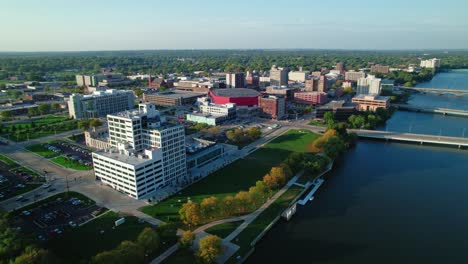 aerial wide landscape shot of the rock river crossing through rockford, illinois during sunset