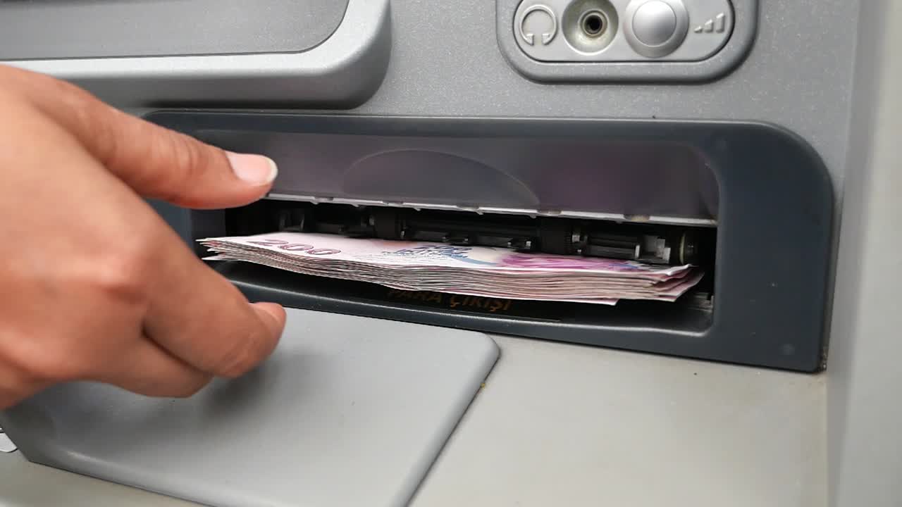 Person withdrawing money from an ATM