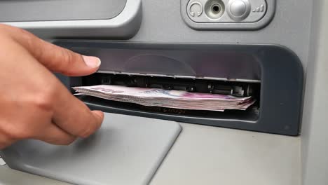 person withdrawing money from an atm