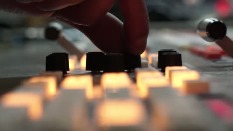 hand adjusting audio mixer
