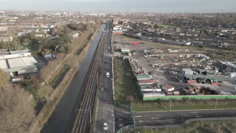 Flying-Over-Busy-Inchicore-Roads-In-Dublin,-Ireland-During-Late-Winter-On-Sunset