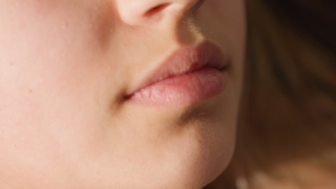 Closeup Caucasian Woman Lips Smiling, Soft Light Sculpts Skin Texture And Gentle Mouth Curve As Model Relaxes Minimal Makeup, Natural Pout Suggests Warmth, Confidence And Approachable Charm