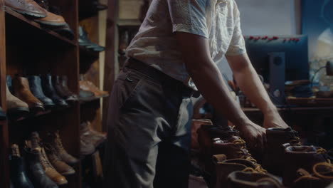 asian seller lacing old leather boots in vintage shop