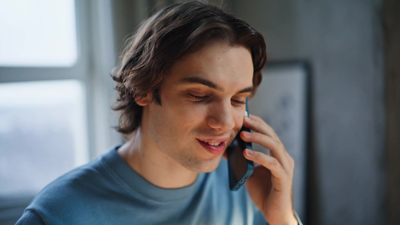 Smiling man speaking call sunlight home portrait. Freelancer work conversation