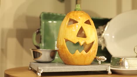 pumpkin head in glass as home table decoration, halloween celebration