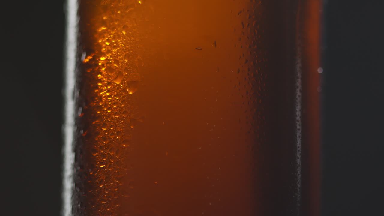 Close Up Of Condensation Droplets On Revolving Bottle Of Cold Beer Or Soft Drink 3