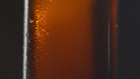 Close-Up-Of-Condensation-Droplets-On-Revolving-Bottle-Of-Cold-Beer-Or-Soft-Drink-3