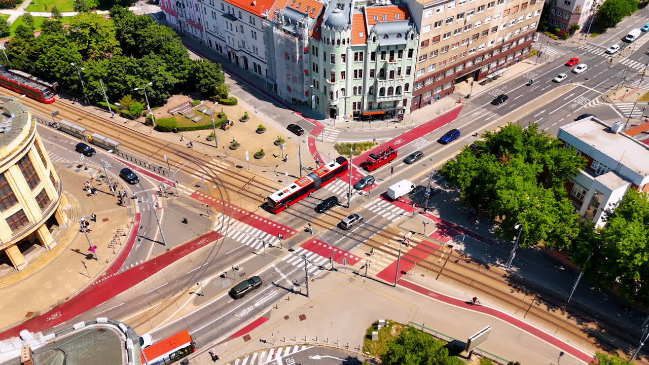 Public and private transport moves by the crossroad of the city. Aerial view on the street in the historical center of Bratislava, Slovakia.