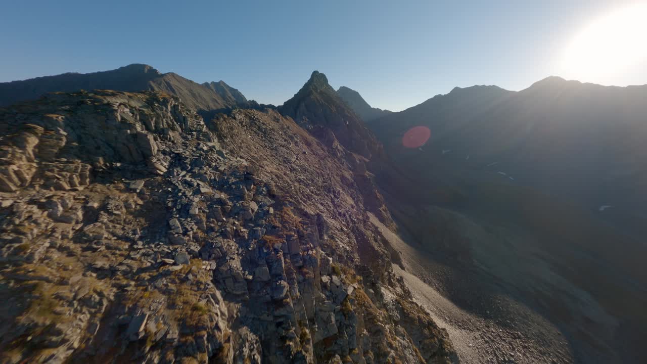 Aerial view mountain ridge structure with communication electricity tower sun light glare