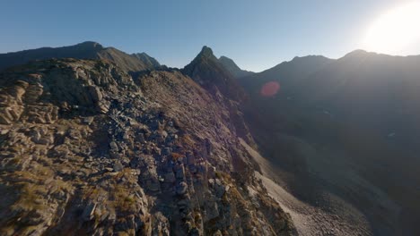 aerial view mountain ridge structure with communication electricity tower sun light glare