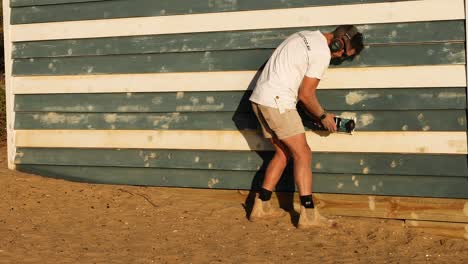 carpenter repairing a wooden structure on brighton beach