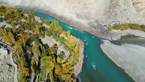 drone shot of a beautiful river flowing in rural skardu city of pakistan