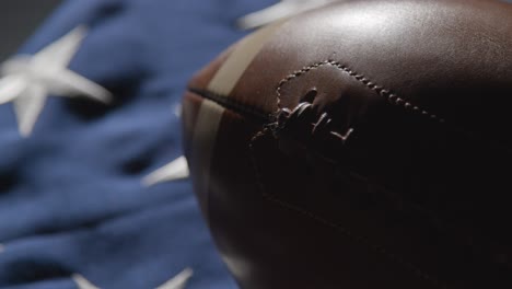 close up studio shot of american football on stars and stripes flag