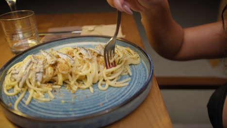 delicious dish of spaghetti with anchovies at the restaurant for dinner
