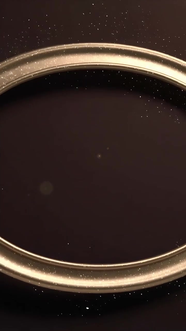 Video verticale: Anello ovale d'oro che ruota in studio, un bagliore che fa depositare la polvere per incorniciare i glitter