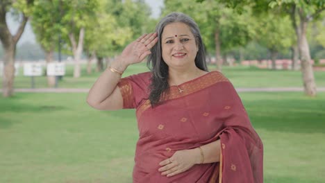 Happy-Indian-old-woman-saluting-in-park