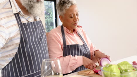 chopping vegetables, senior couple cooking together in kitchen, enjoying meal prep