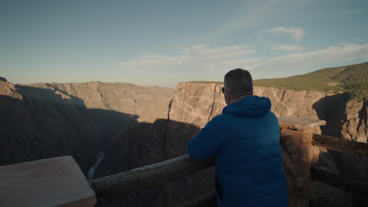 Man enjoys canyon view from overlook