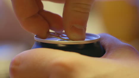 opening a soda can with fingers