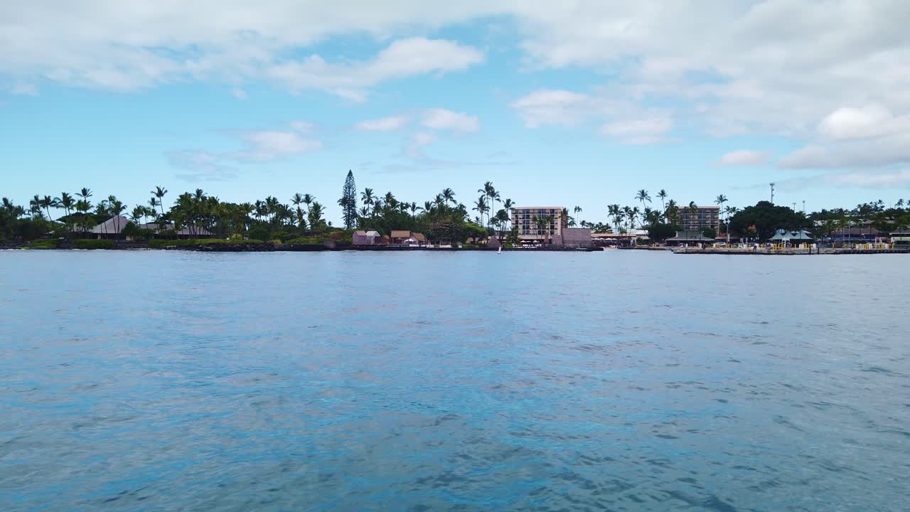 Gimbal wide POV shot from a moving boat approaching Kailua Bay on the Big Island of Hawai'i