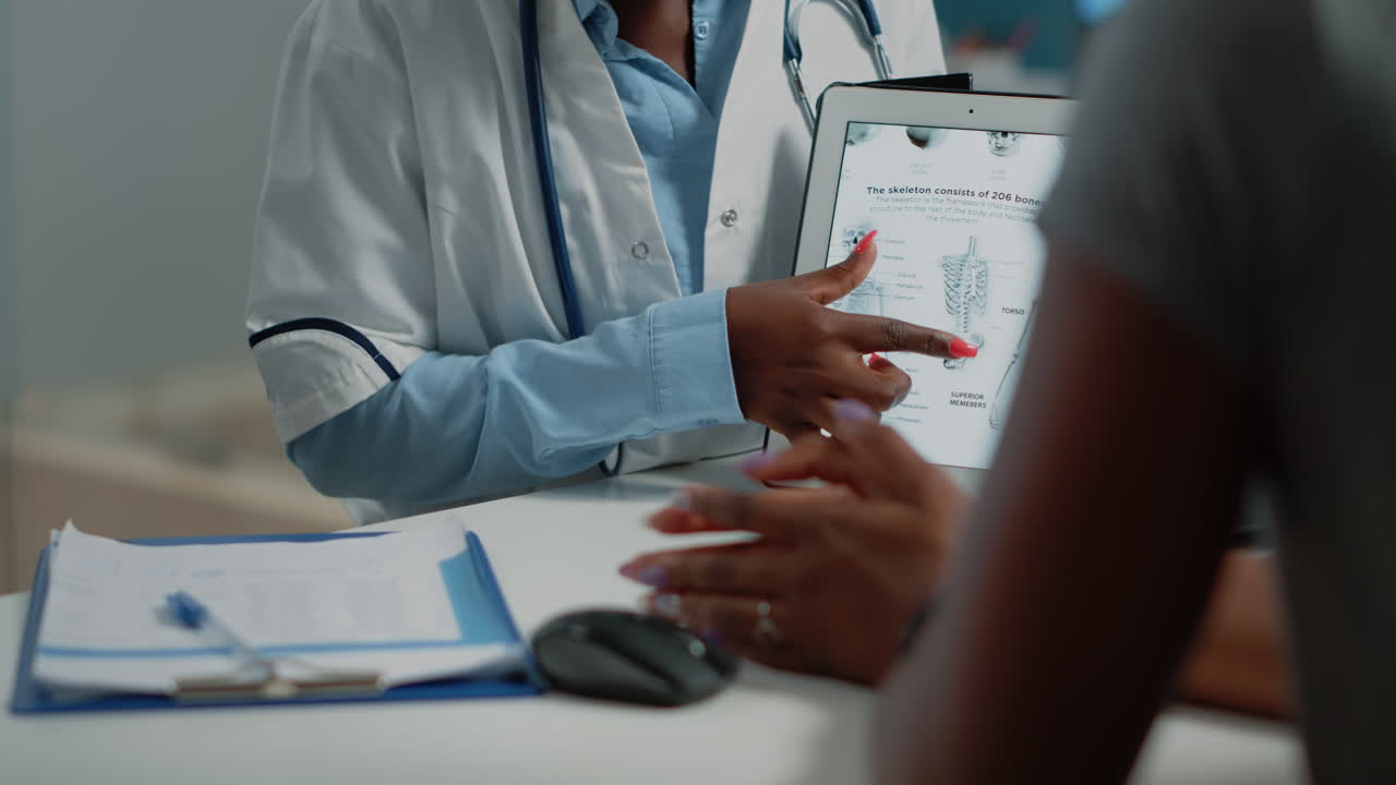 Doctor explaining x-ray to patient on tablet