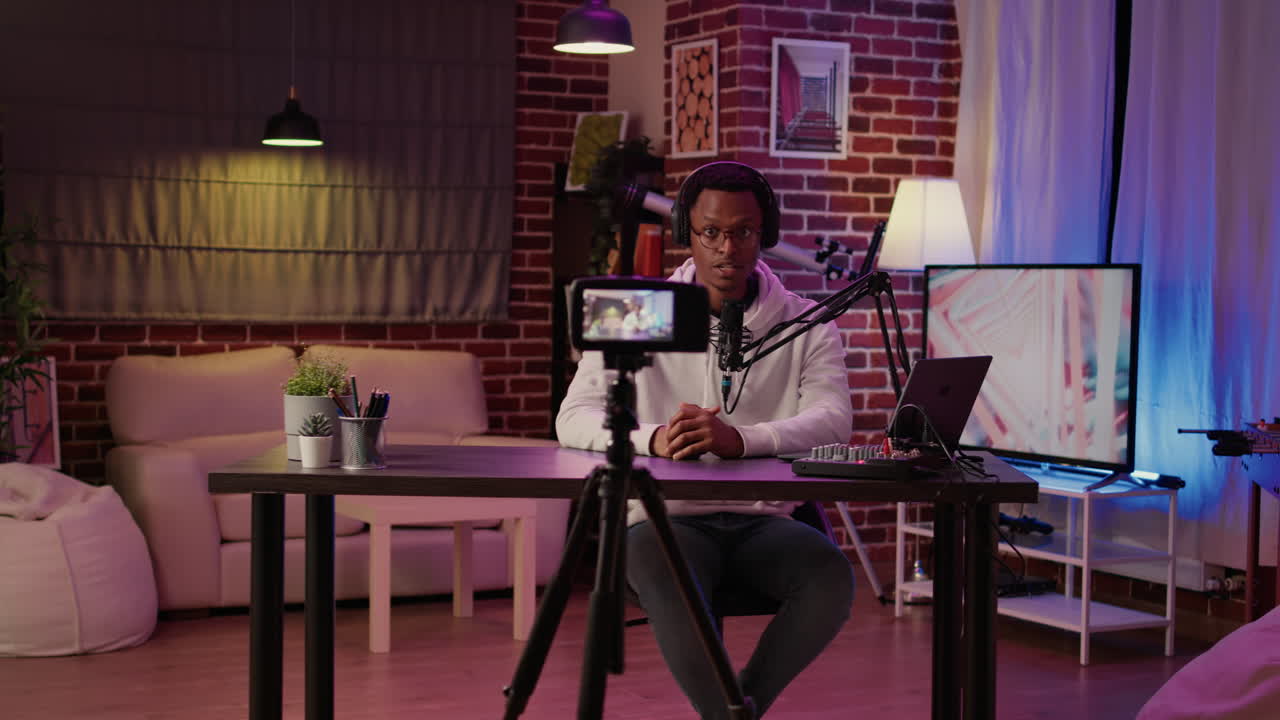 African american influencer recording podcast using digital video camera for vlog post