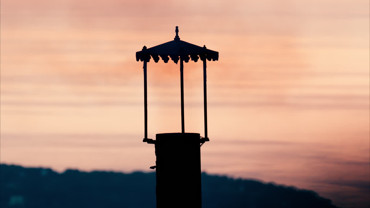 Aerial view a lighthouse with the Eze seaside commune in the Alpes-Maritimes at sunset on the background