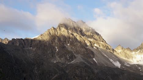 timelapse of clouds and sunlight passing over a rocky mountain in the nelchina public use area of alaska